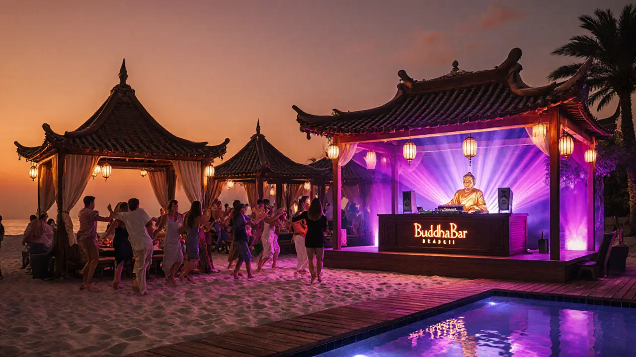Buddha‑Bar Beach at dusk with dancing guests and lantern‑lit cabanas.