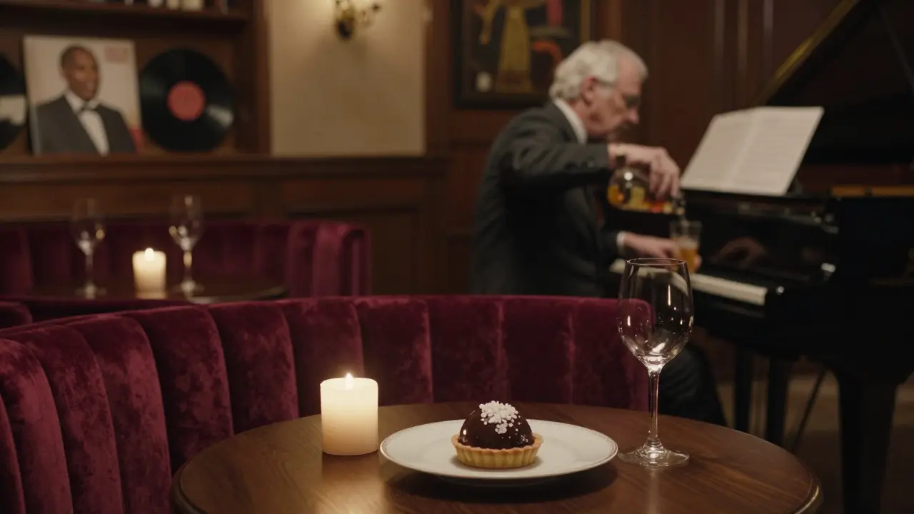 Candlelit bar at La Perle with a pianist, velvet booths, and a chocolate tart on the counter.