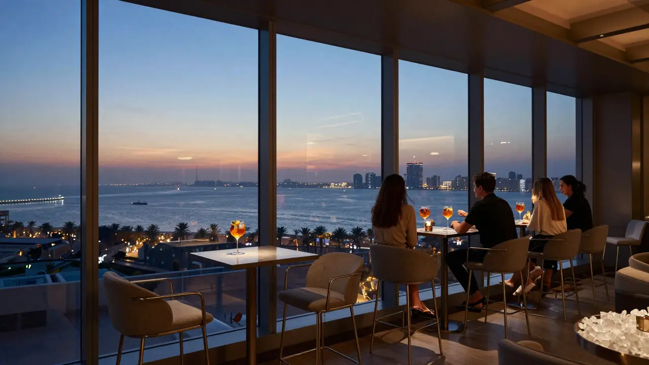 Rooftop bar at twilight with city lights reflecting on the Gulf and elegant cocktails.
